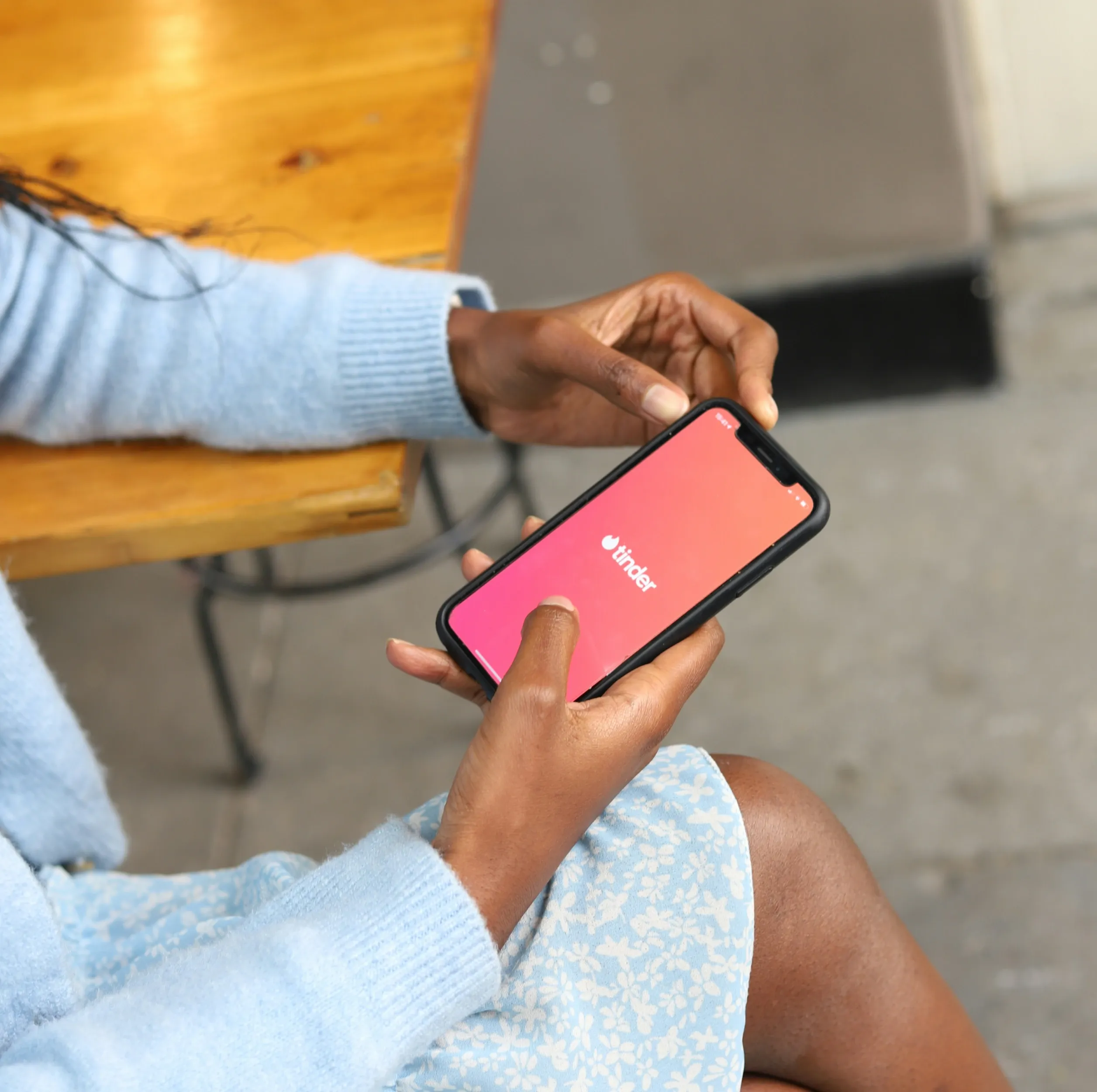 An image showing a woman using a dating app on her mobile.